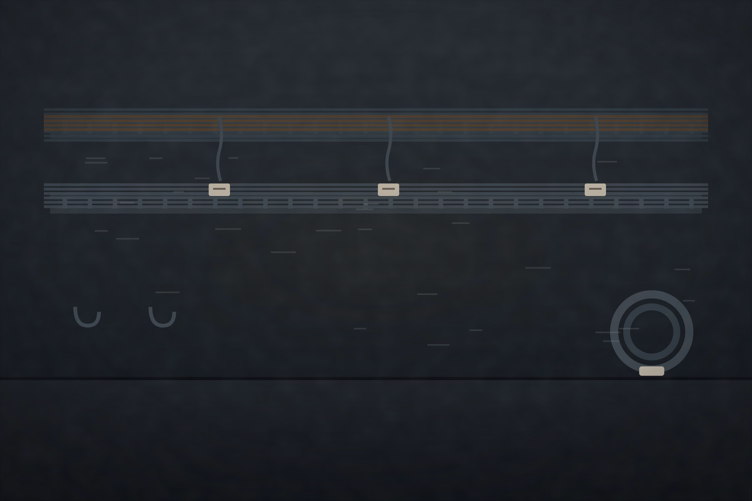 Cable trays along a machine room wall with labelled wiring runs, tags at each end, and a coiled spare pair on hooks.